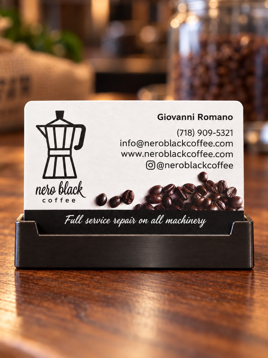 Nero Black Coffee business card on a holder